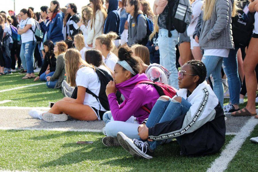 Freshmen Tristynn Smith and Jasmine Roland listen as presenters speak about the importance of kindness. The presenters promoted kindness and anti-bullying as a way to help prevent another school shooting.