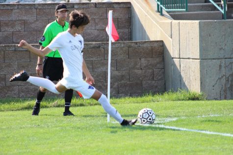 Senior Luke High kicks the ball back in during the remaining minutes of the game.