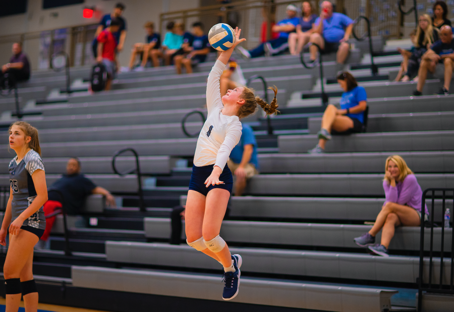  Sophomore Eryn Taber (JV) reaches high to serve to the competing team at the August 27th pre-season scrimmage where the JV team plays the Varsity team.
