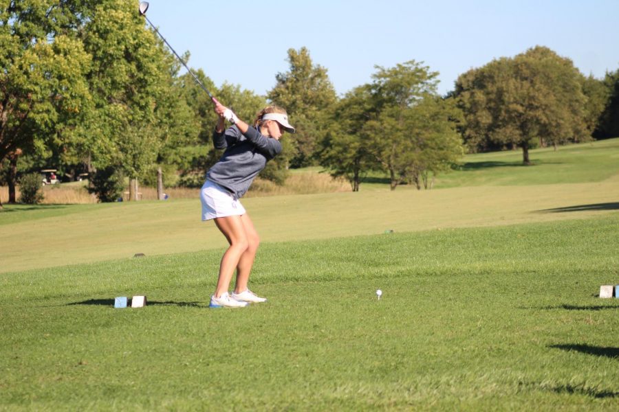 Kendall Starcevich practicing her swing getting ready to tee off on hole one of the course.