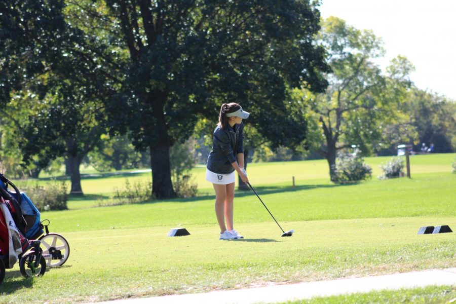 Lyons practices her swing before she tees off on the second hole of the course.