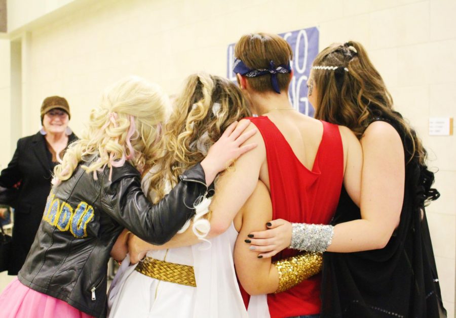  Four cast members including sophomore Kalista Brown (far left), sophomore Lexi Eckles, senior Weston Curnow, and senior Peyton Falen (far right), share a group hug as they pose for a picture after the show. 


