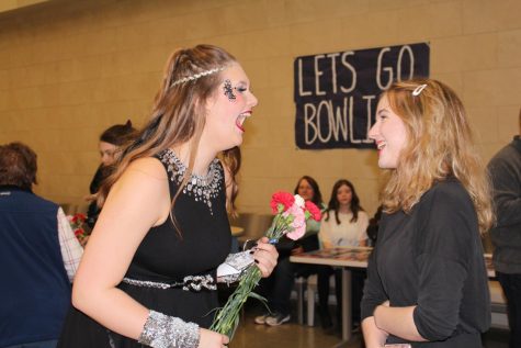  Cast member and senior Peyton Falen laughs with stage manager and junior Summer Sperke, while holding onto a handful of flowers and handwritten notes that the audience members had a chance to write before the show and during intermission. 
