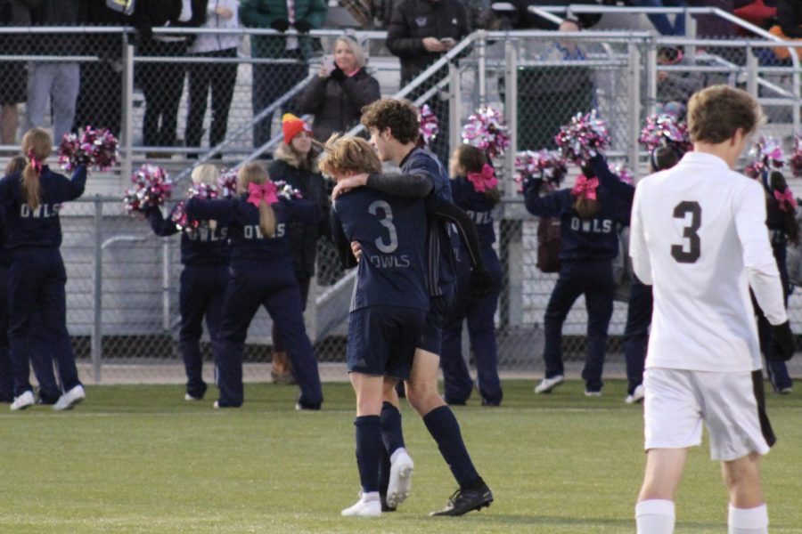 Junior Henry Curnow and senior Cameron Denton celebrate a goal made in the game against Olathe Northwest.