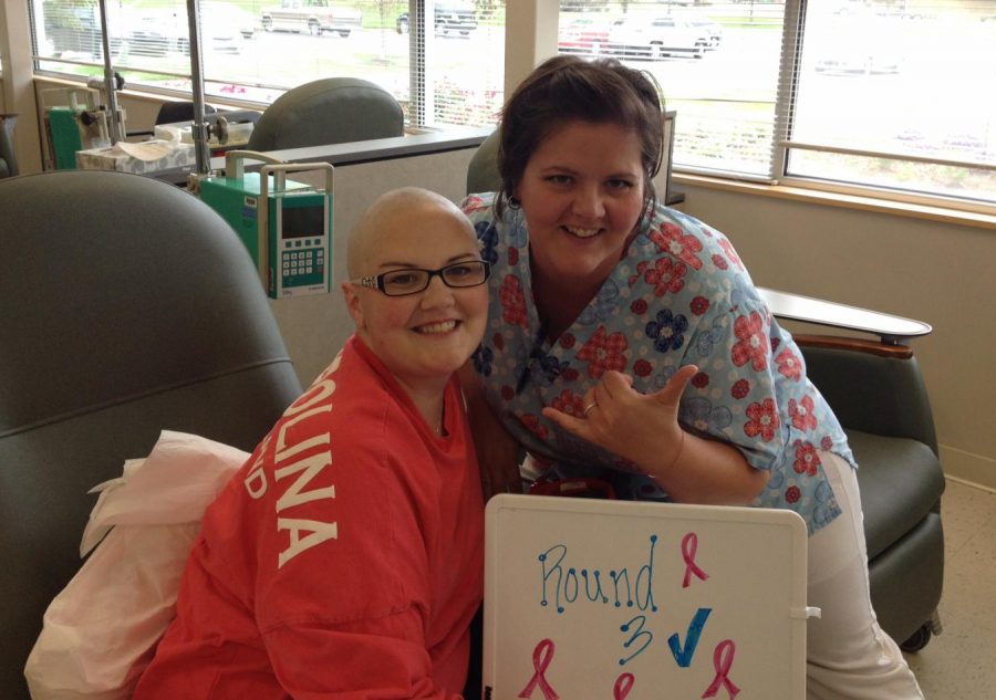 Angela Holtgraves smiles with a nurse after undergoing her  third round of chemotherapy.