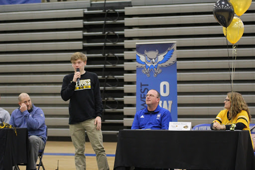 Senior Nathan Rouse introduces his mother and father before signing with Ottawa University for football.