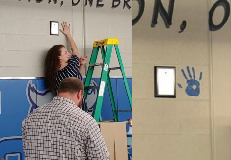 Makayla Rivera leaves the first of many handprints on the wallf of Olateh West to commemorate her work through the wrestling season.