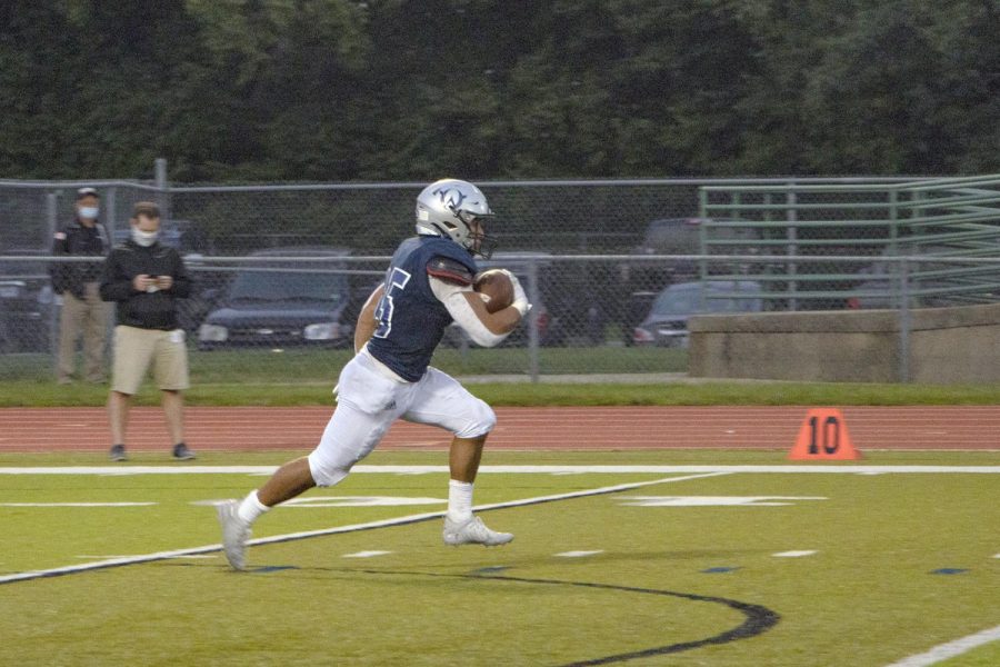 Junior Anthony Favrow runs down the field to score the first touchdown for the Owls.
