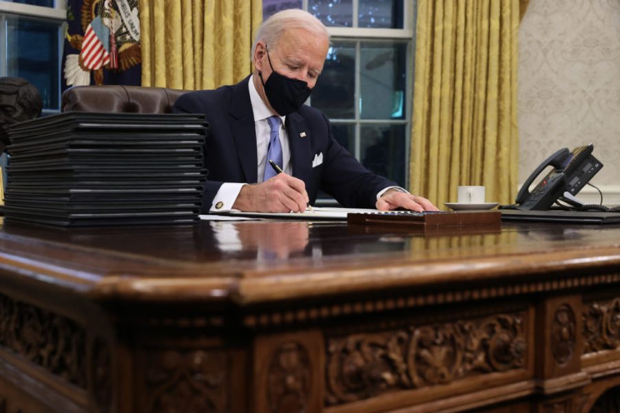 President Biden works in the oval office the day after inauguration.