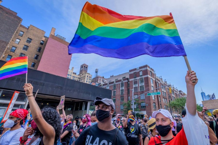 Masked+people+walk+the+streets+of+New+York+City+for+Pride.