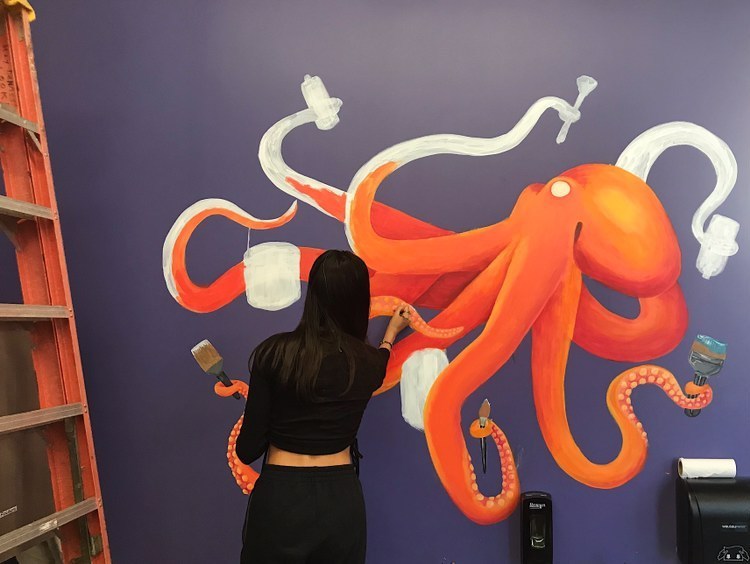 Junior Lana Young adds details to her acrylic mural of an octopus.
