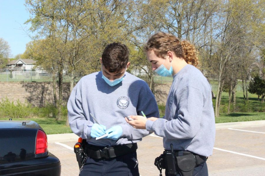 Seniors Kobe Pointdexter and Caleb Keith take notes on the condition of the crime scene after assessing it.