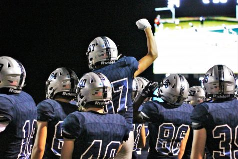 The football team celebrates their first home game win against Shawnee Mission Northwest on Sept. 9. 