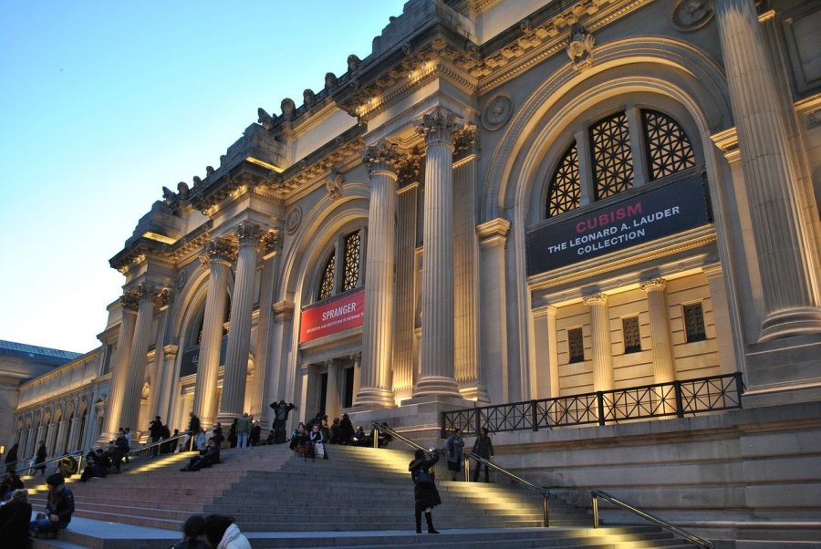 The Metropolitan Museum of art with its lights on in New York city. 