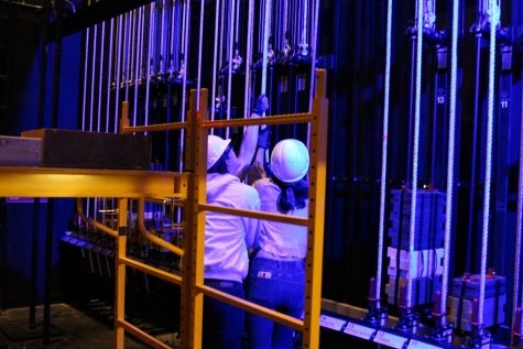 Director Alisha Morris, senior Evan Hessler and senior Hailey Brooks use the cable lifts in the auditorium to lower and lift poles at the ceiling of the space. The job involves Morris yelling cues to the crew and to anyone else who is on the stage. 