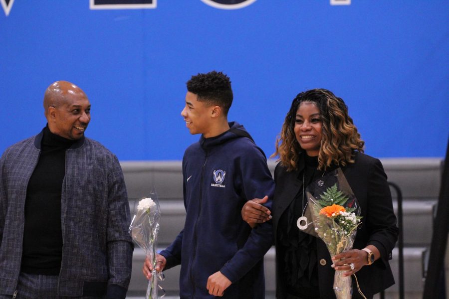 Senior Maurice Coleman walks the court with his family for the senior night ceremony on Feb. 22.