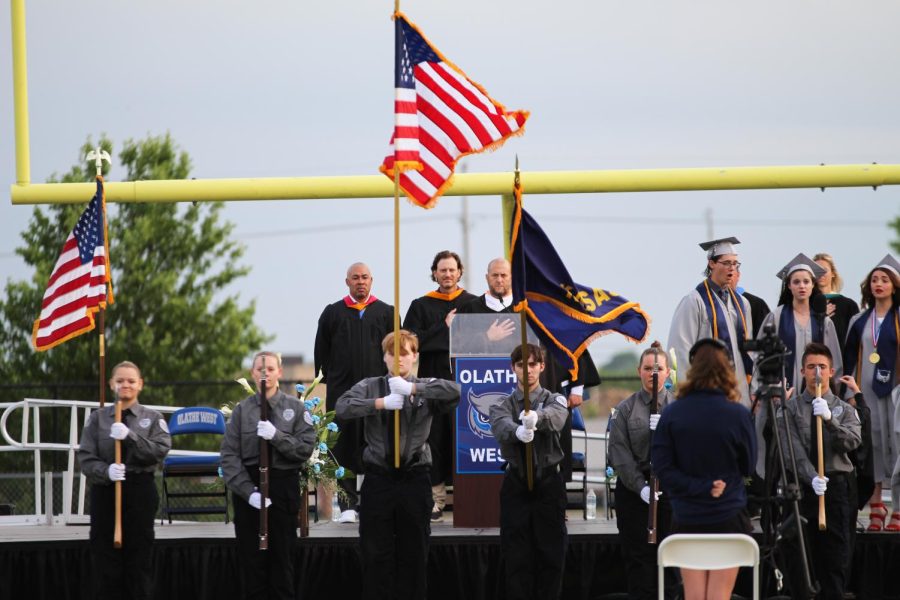 Public Safety students hold the flags during the National Anthem.