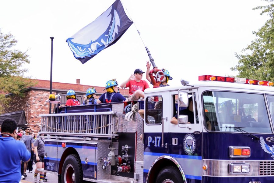 Public Safety holds flag while participating in parade.