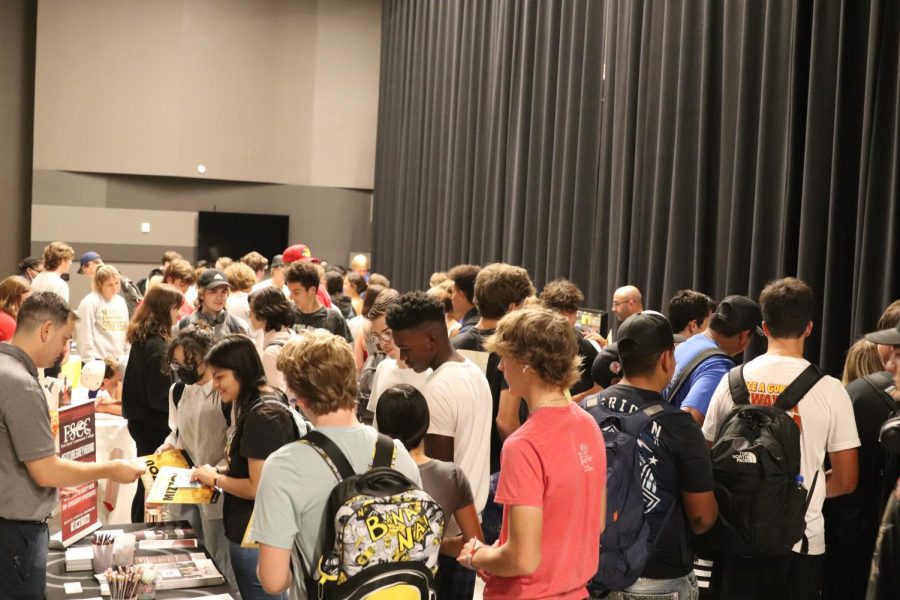 Students attending booths at the college fair.