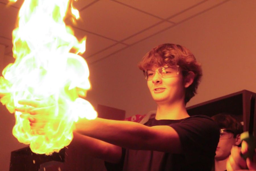Participating in the College Chemistry classes’ Chem-o-ween experiment, Ty Normandin carries combustible bubbles on Oct 31.