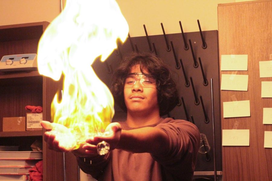 Volunteering for an experiment, Jesus Valencia Garcia holds fire during a Chem-o-ween presentation on Oct 31.
