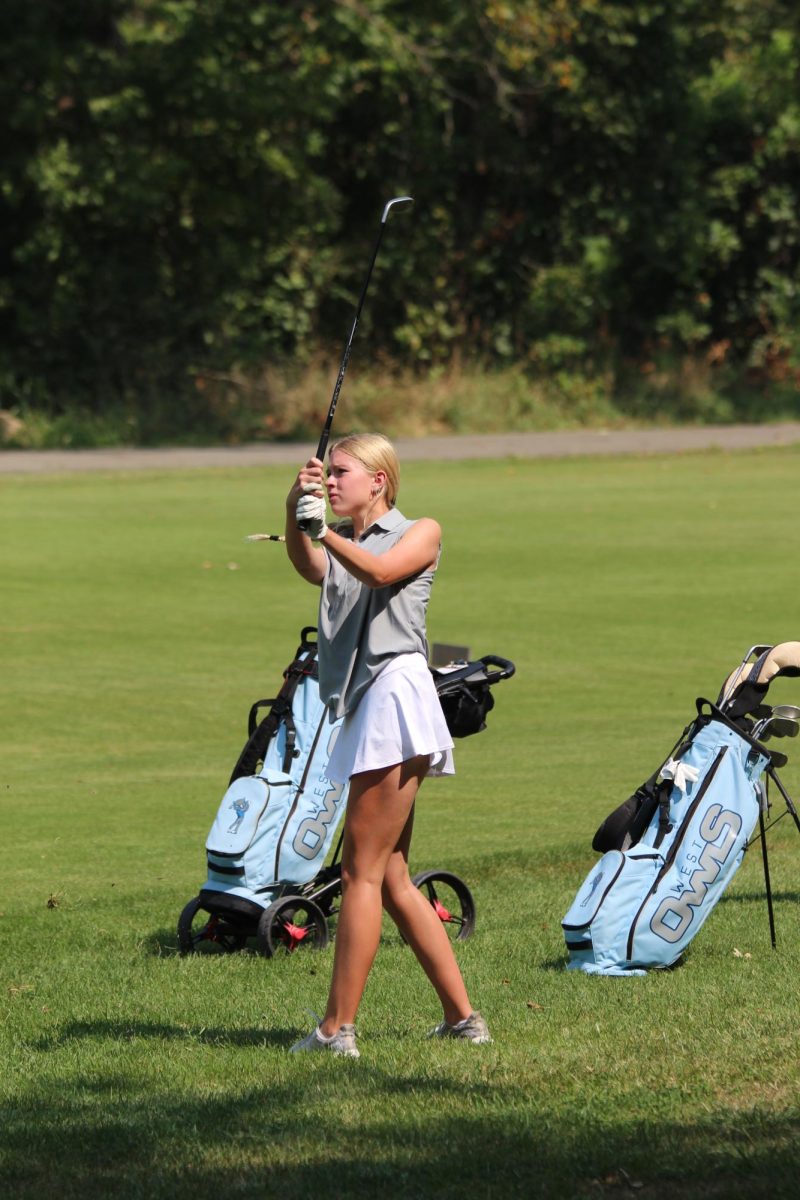 At the Varsity golf tournament against Shawnee Mission-North, Junior Maddie Wegmann after taking her shot.
