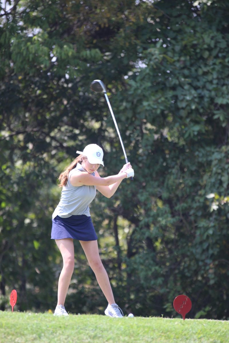 Ava Mars, a Varsity golfer after taking her shot in the tournament against Shawnee Misson-North.
