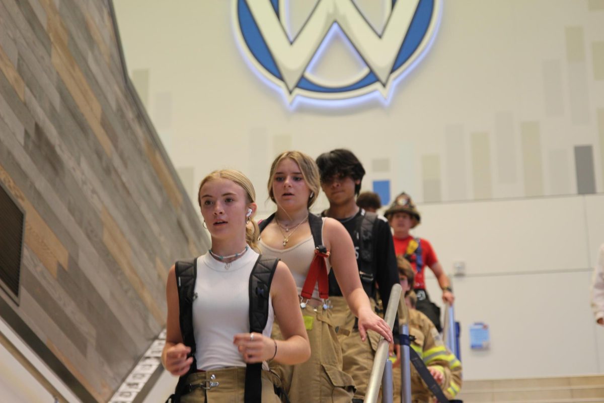 Sophomore Reia Waliser completes the stair climb on with her class following behind her.