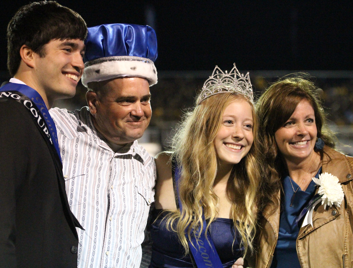 Senior royalty winners Ty Huber and Gabby Clinkinbeard pose with parents after being announced as the homecoming king and queen.
