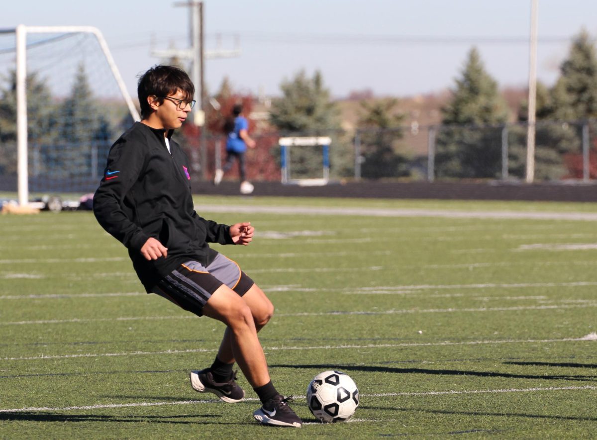 BLANK, kicks the ball towards his friend a he participates in the walk-a-thon.