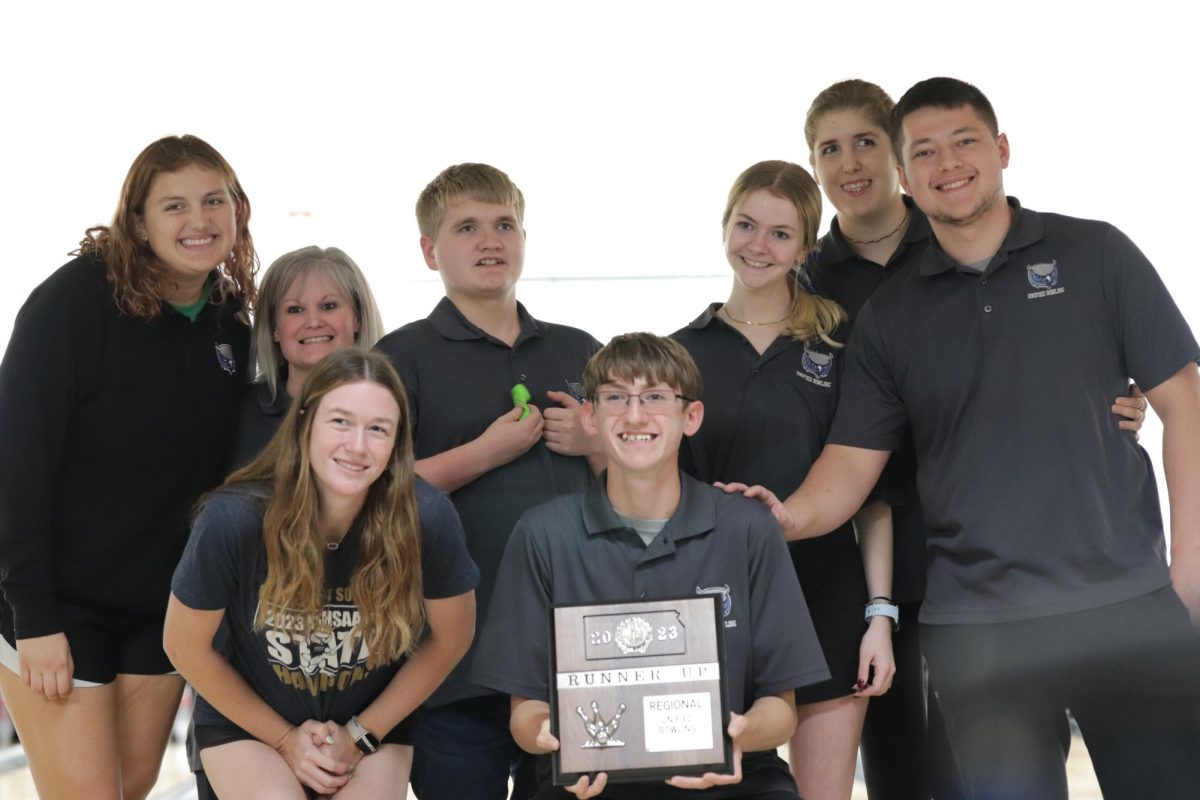 The unified bowling team poses holding their runners up plaque after the regional championship.
