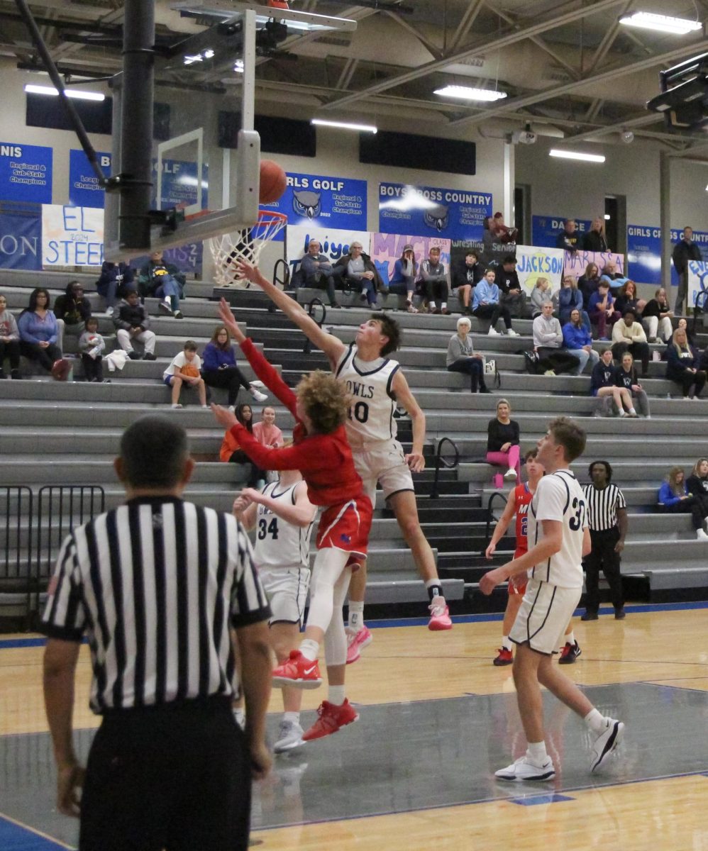 Ben Boswell blocks as Bishop Miege goes up for a layup  