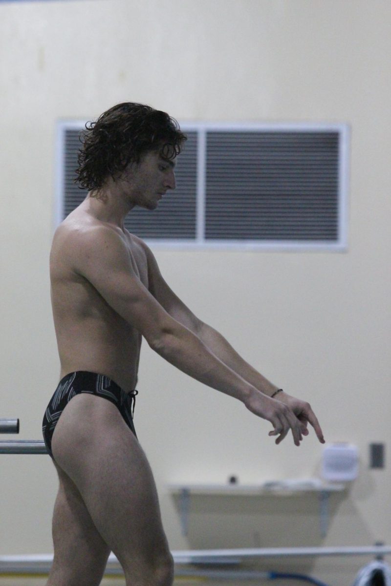 Junior Dolan Capps takes a moment on the diving board before performing his dive.