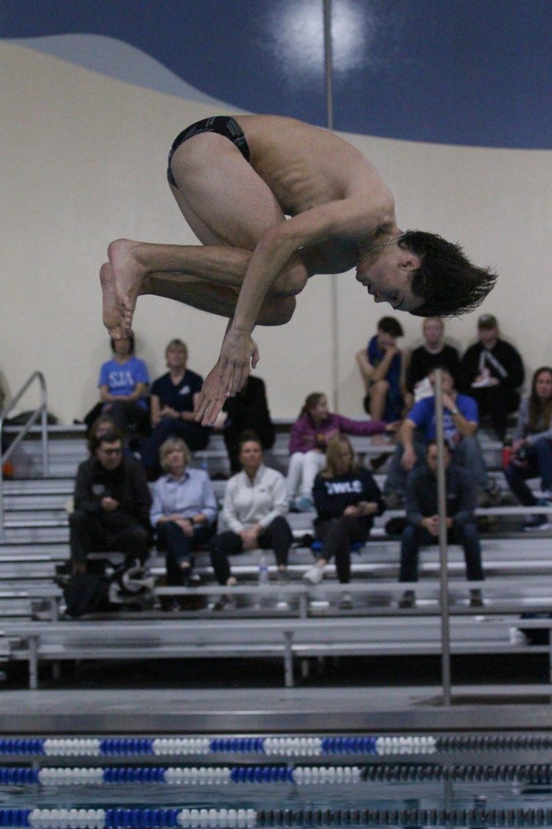 Sophomore Eli Mills executes a backflip off the diving board.
