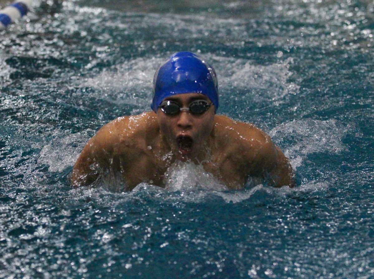Junior Luis Contreras comes up for air while competing in the butterfly stroke.
