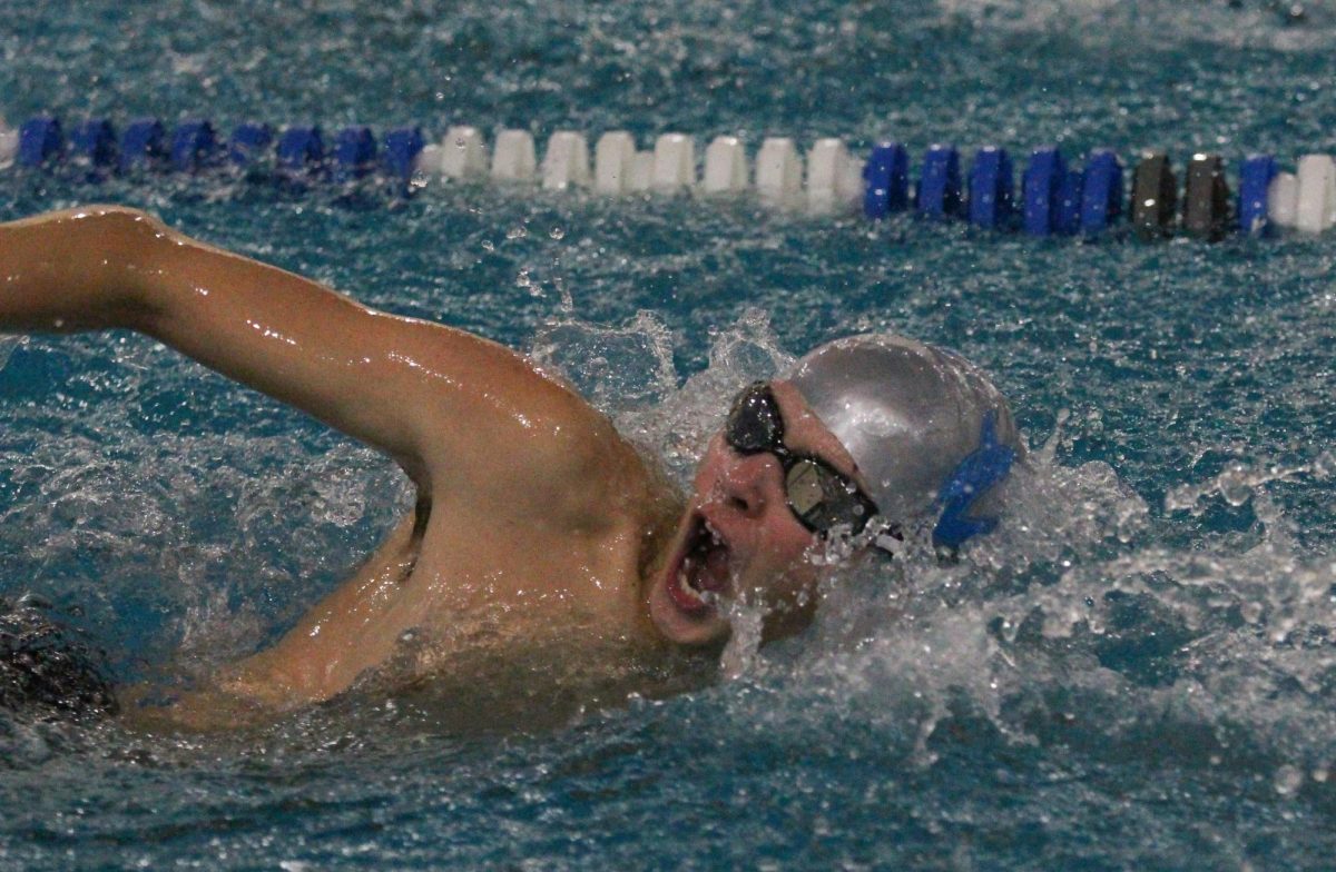 Junior Aaron Shirley competes in the 50 freestyle at the swim meet.
