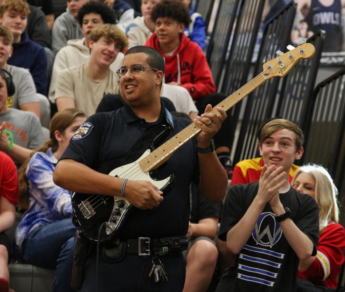 SRO officer Quintin Locke plays the bass guitar as he participates in the musical game where you try to play a song with a random instrument and the crowd tries to guess.  