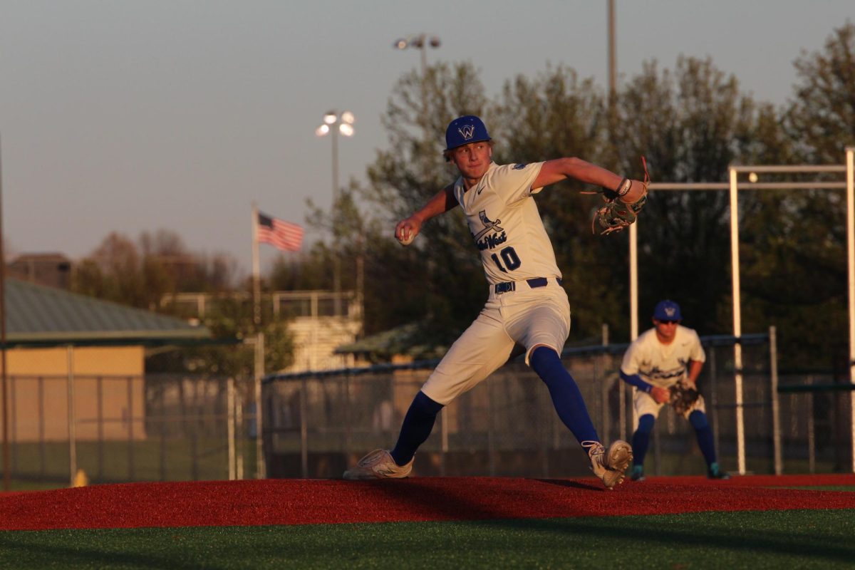 Junior Ty Miller pitching during the varsity game against Shawnee Mission-East on April 4.