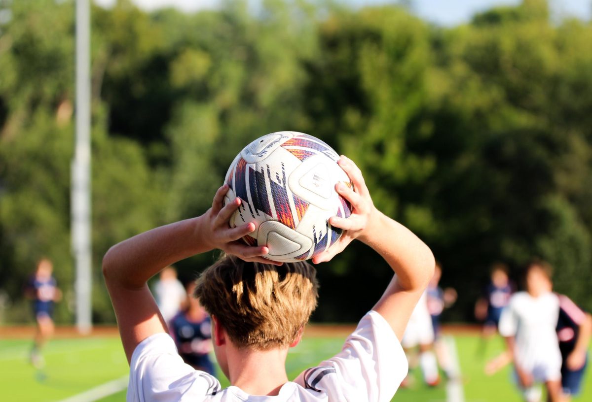 Sophomore Drake Thomas throws the ball over his head during the JV soccer match.