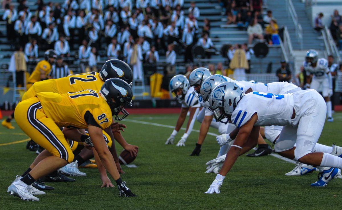 The Owl defense lines up against Shawnee Mission West on Aug. 30.