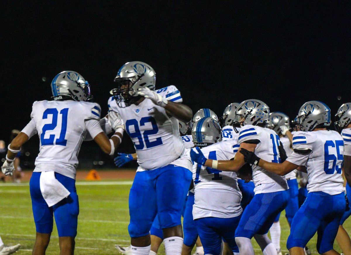 Juniors Brody Butler (21) and Jalen Johnson (92) celebrate after the win.