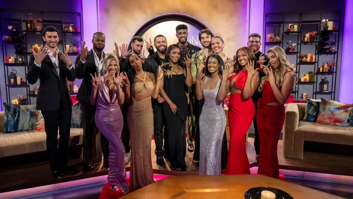 Group picture of Love is Blind contestants holding up the number seven.