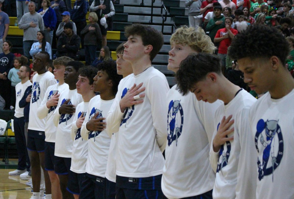 The Owls stand for The National Anthem before the game