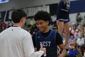 Sophomore Malachi Buckner and senior Ben Boswell share a handshake before the game against Olathe Northwest