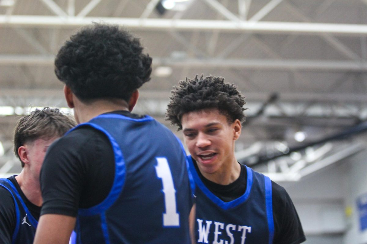 Senior Kevin Hollinger celebrates with junior Malachi Buckner after a crucial score