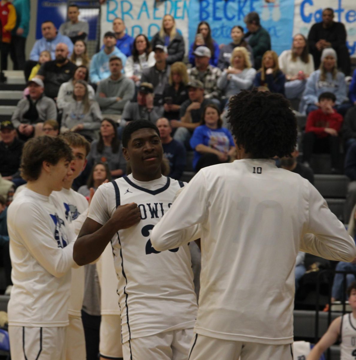 Junior David Harper does a handshake with sophomore Juju Kinnie 