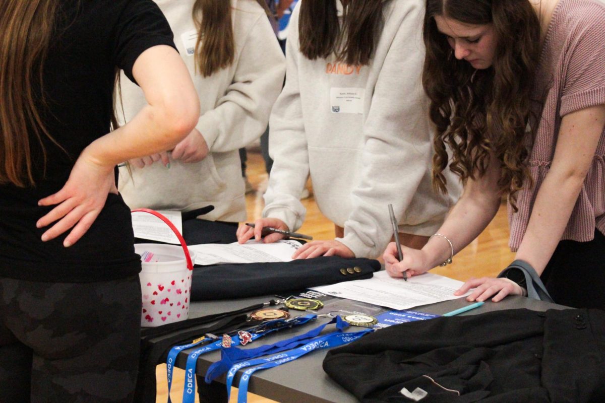 Deca students teach eighth graders about their club at the activity fair.