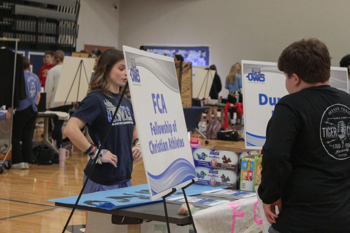 Junior Kennedy Heideman introduces the Fellowship of Christian Athletes to eighth graders.