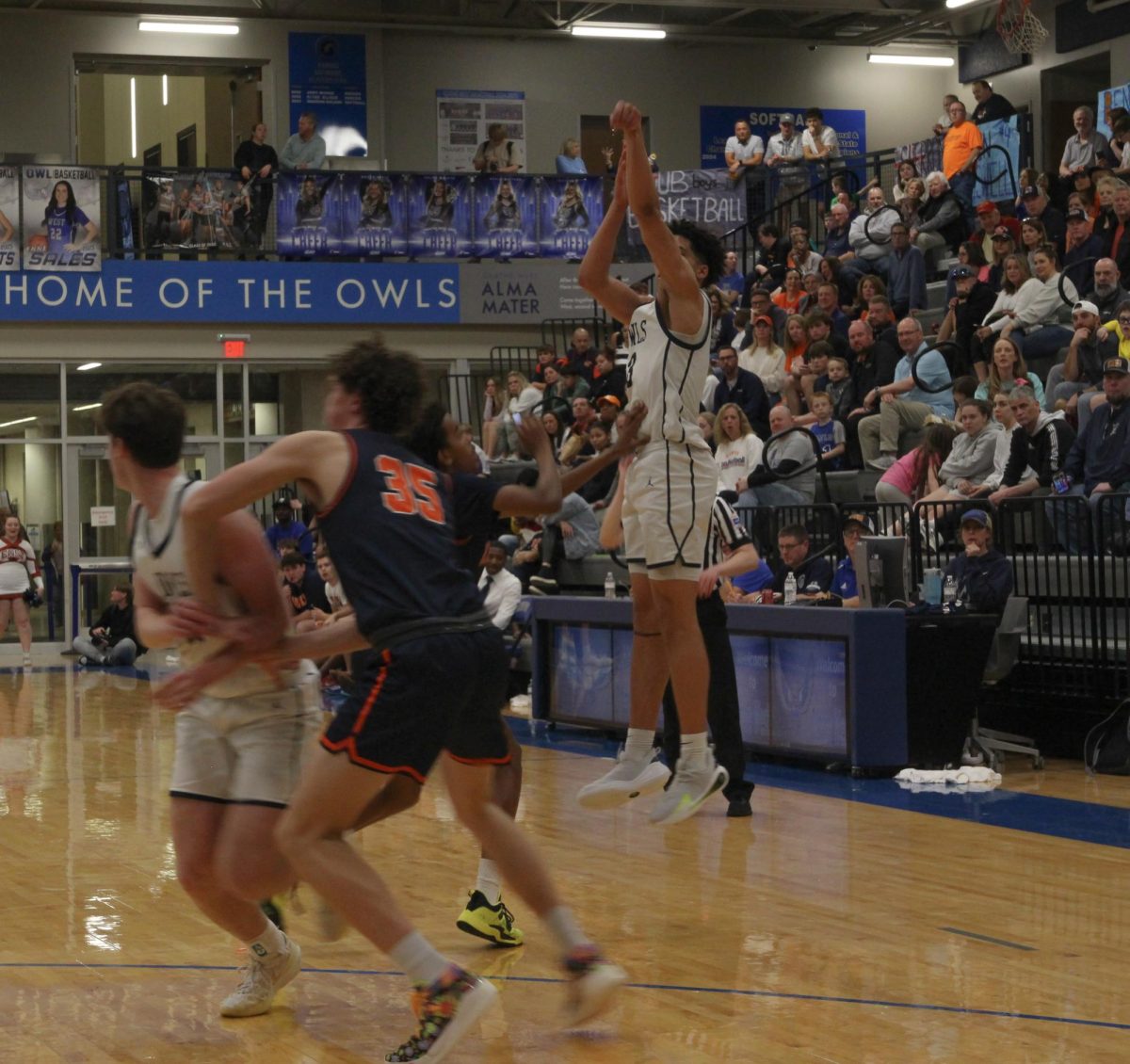 Senior Sherron Woodbury shoots a three-pointer vs Olathe East