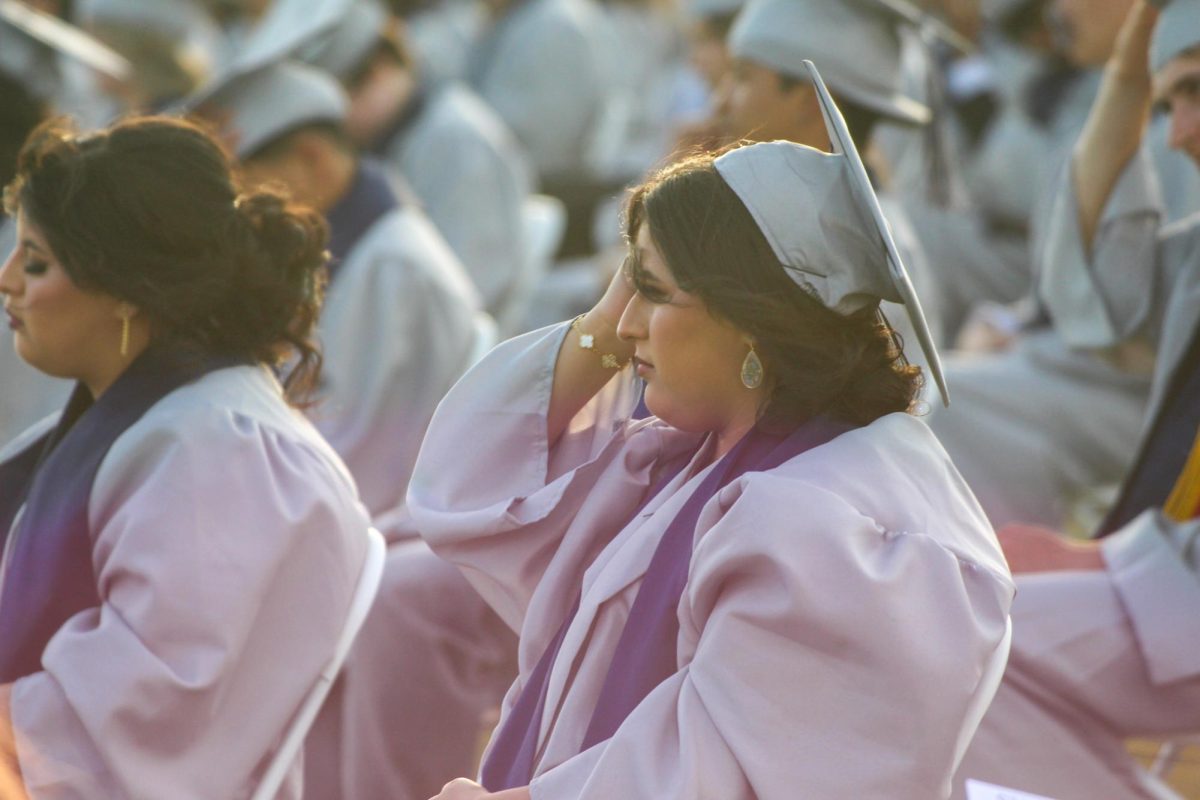 From left, seniors Kassandra Gonzalez and Kenya Gonzalez looking towards the speaker.